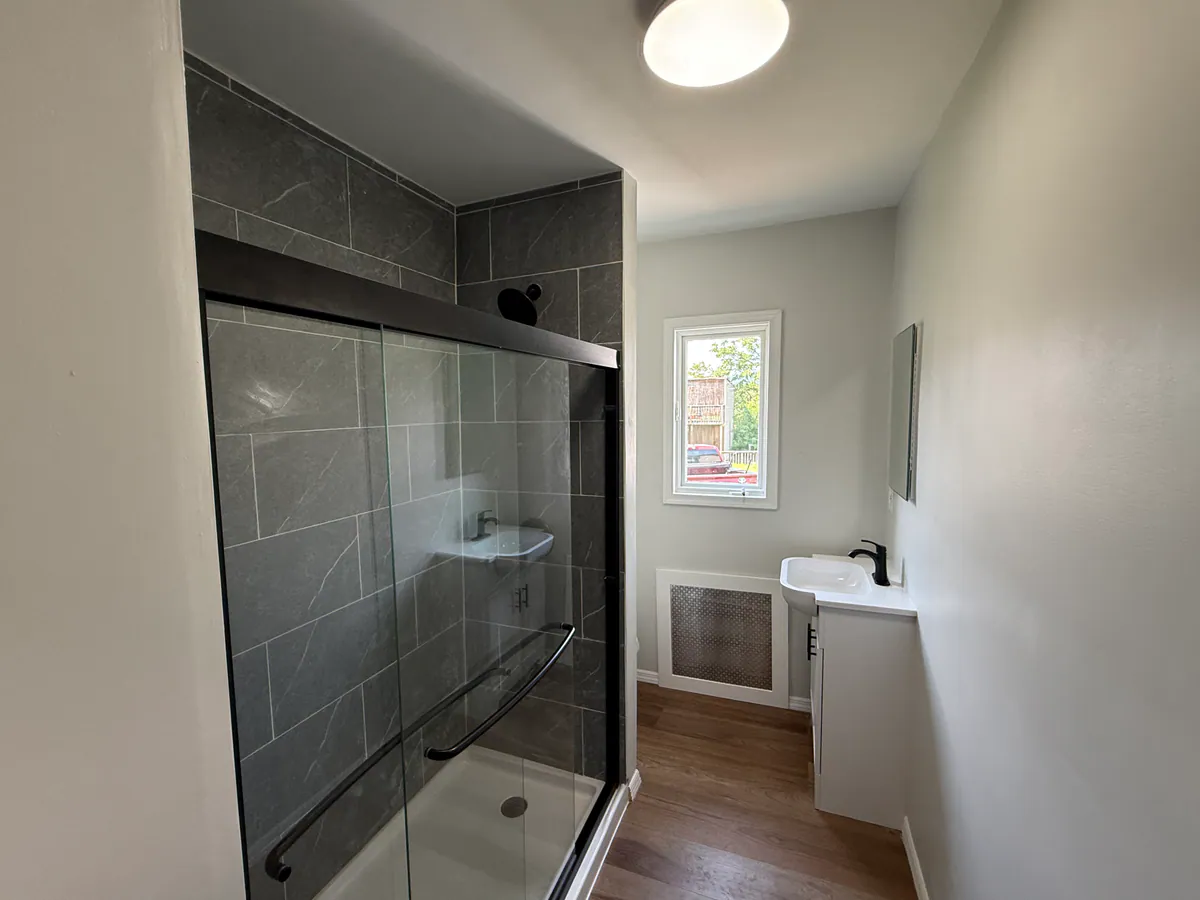 Renovated main bathroom at 4036 Birney Avenue in Moosic with a tiled shower and updated vanity