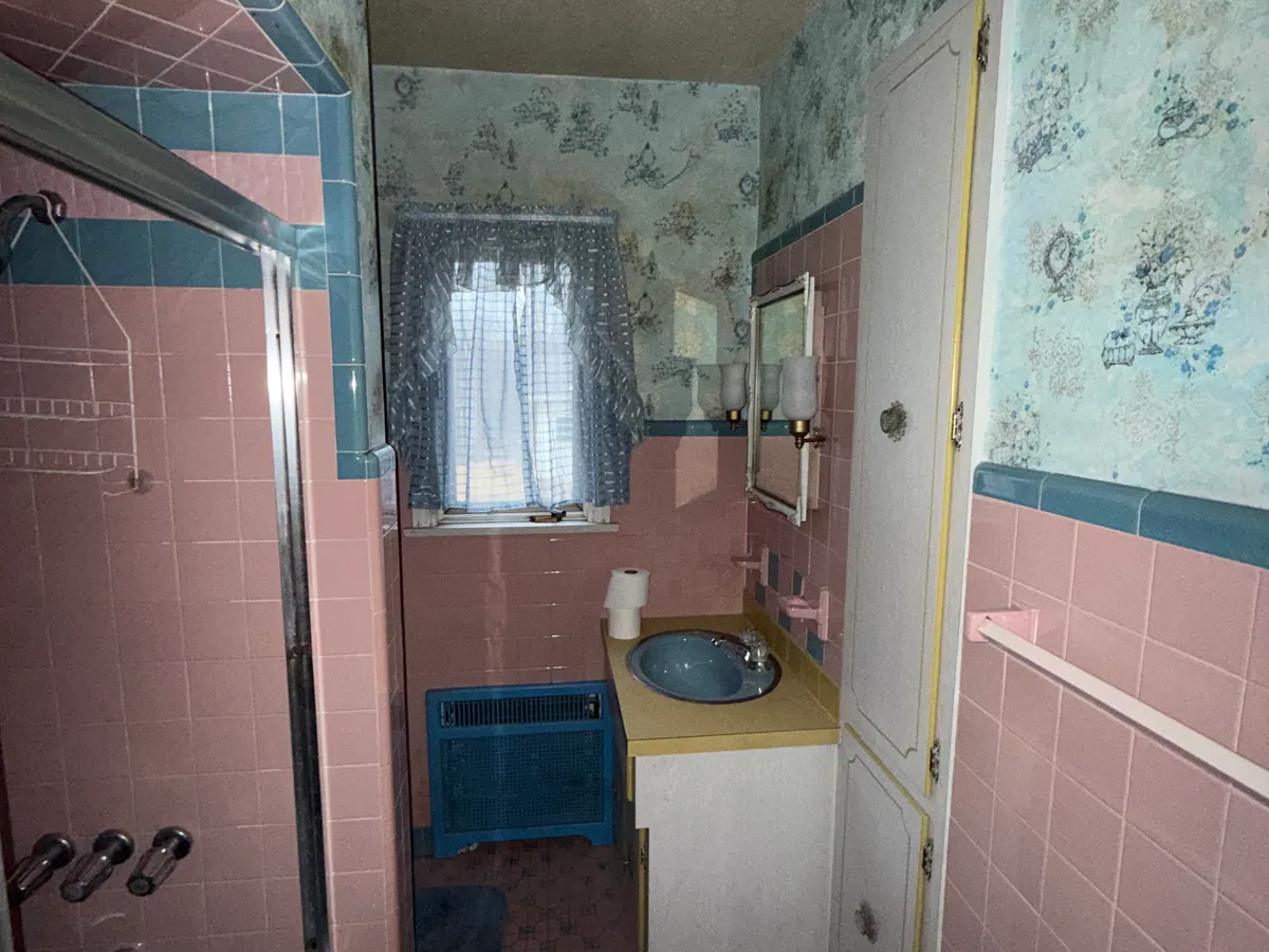 Pink and blue main bathroom at 4036 Birney Avenue in Moosic before renovation