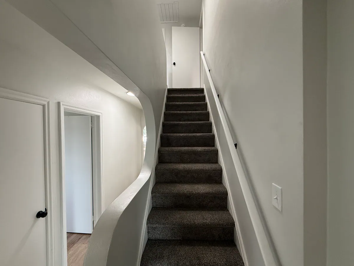 Renovated stairway at 4036 Birney Avenue in Moosic with new carpet and painted walls
